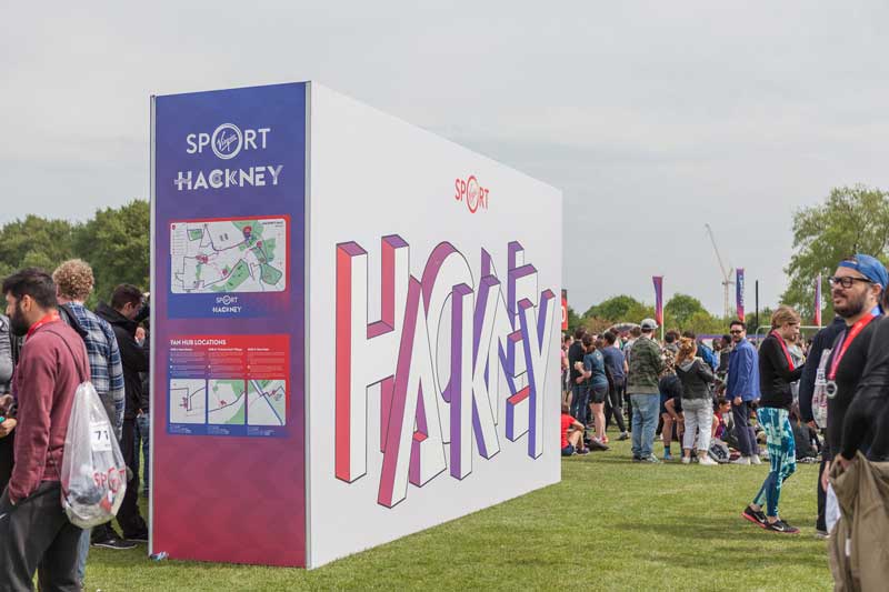 Large super-graphic wayfinding and photo backdrop at the Hackney Half Marathon